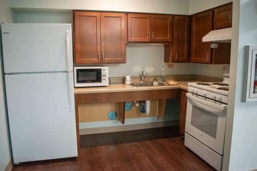 a kitchen with white appliances and wooden cabinets