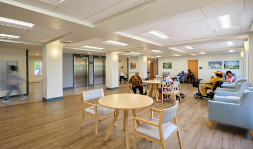 A room with a wooden floor and a table with chairs.