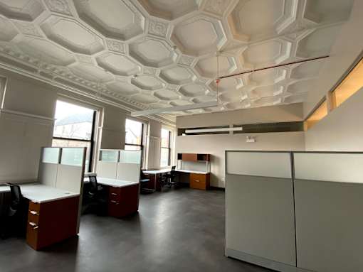 A white ceiling with a geometric pattern and a red line running through the middle.