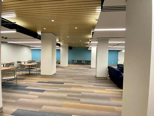 A spacious room with a wooden ceiling and a patterned carpet.