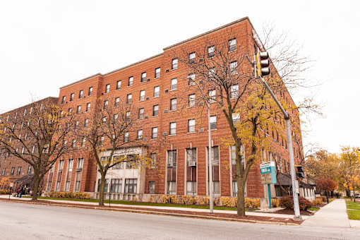A large red brick building with a blue sign on the front.