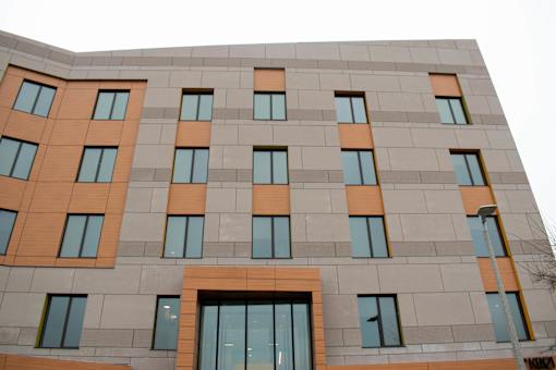 A building with a grey facade and orange accents.