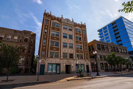 A brown building with a blue building in the background.