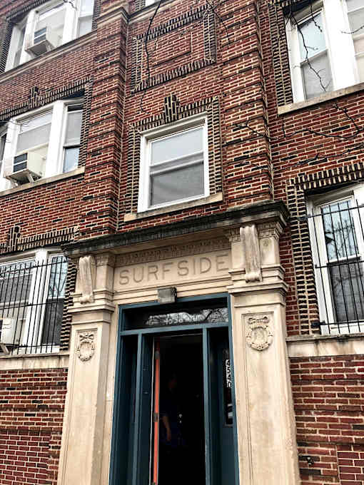 A building with a window that has a sign that says Surfside on it.