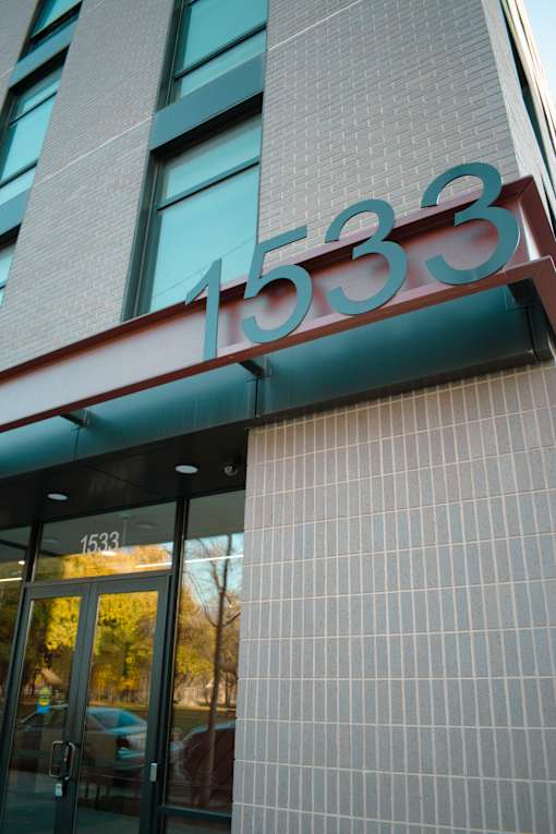 A building with a glass door and a sign that reads 1533.