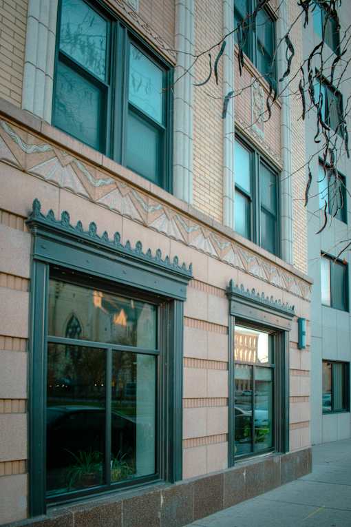 A building with a pink facade and a large window.