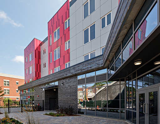 A modern building with a red and grey facade.