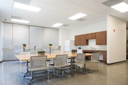 A conference room with a long table and chairs.