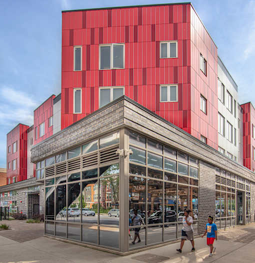 A red and white building with a large glass entrance.