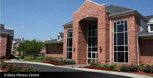 Luxury apartments with huge fitness center, indoor lap pool, sauna, workout stations, cardio equipment, and peloton bike at The Biltmore Apartments in Omaha, Nebraska