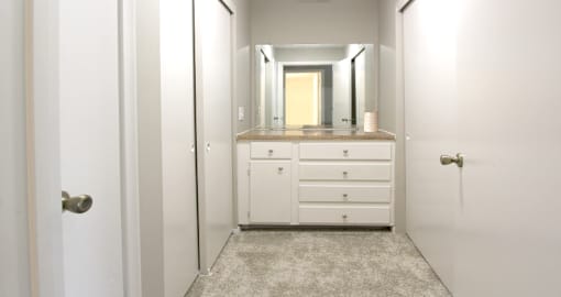 Recently updated apartments with gray wall color, white cabinets, and extra storage space at Kensington Woods Apartments in Omaha, Nebraska