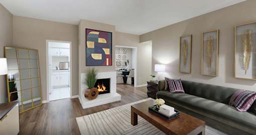 A living room with a fireplace and a painting on the wall.