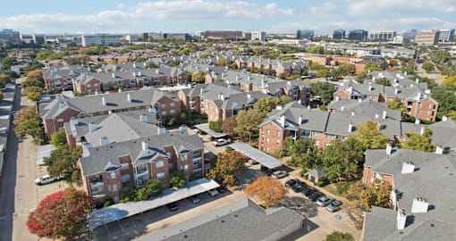 Gated luxury apartment community in north Dallas with red brick exteriors at The Saxony Apartments