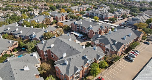 Gated luxury apartment community in north Dallas with red brick exteriors at The Saxony Apartments