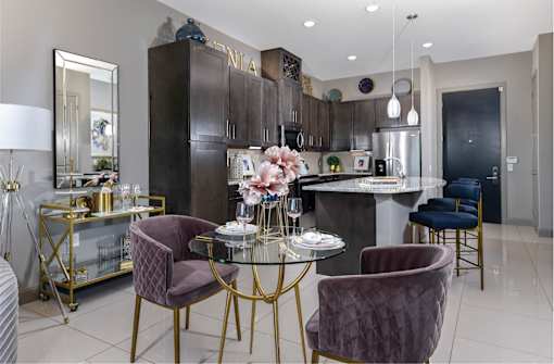 Spacious luxury apartments with porcelain tile floors, dark wood cabinets, and granite countertops at Xenia Apartments in Golden Valley, Minnesota