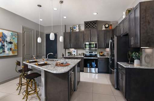 Luxury apartments with spacious floor plan, granite countertops, stainless steel appliances, built-in wine rack, kitchen island, and porcelain tile floor at Xenia Apartments in Golden Valley, Minnesota