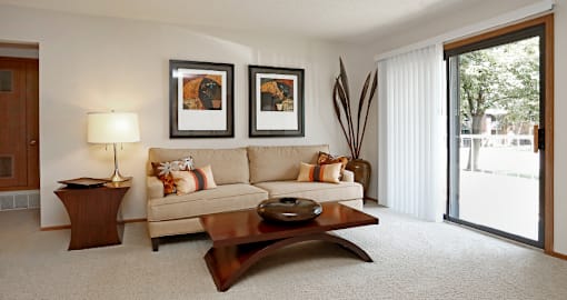 Spacious living room with large balcony at LionsHead Apartments in Omaha, Nebraska