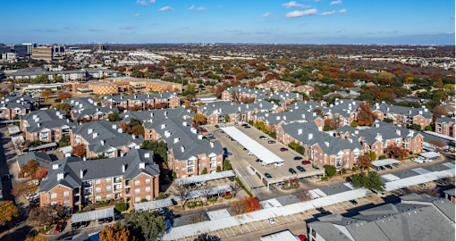 Gated luxury apartment community in north Dallas with red brick exteriors at The Saxony Apartments