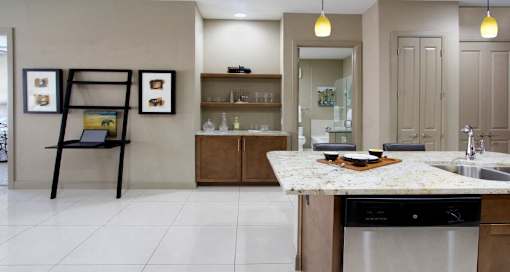 Luxury apartments with spacious open floor plan, porcelain tile floors, and built-in buffet with granite countertop at Bellemeade Apartments in west Des Moines