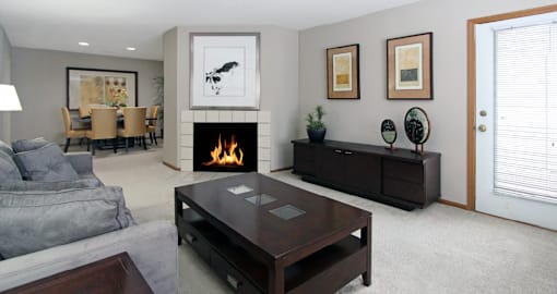 Spacious floor plan, open floor plan, spacious apartment with woodburning fireplace, spacious dining room, and gray wall color at The Vanderbilt Apartments in Omaha, Nebraska