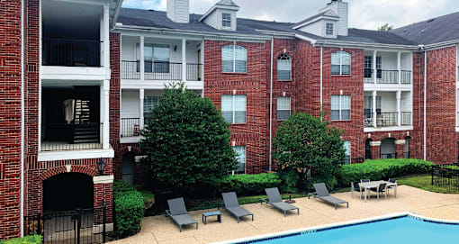 Luxury swimming pool with large sundeck at Tuscany Gate Apartments in Houston.
