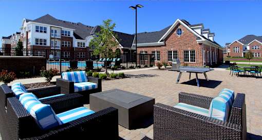 Luxury apartments with swimming pool, poolside lounges, grilling station, ping-pong table and brick exteriors at Bellemeade Apartments in west Des Moines
