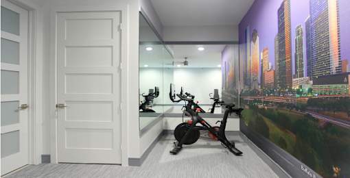 Newly remodeled Fitness Center open 24/7 with brand new Life Fitness equipment including 1 peloton bike, 4 resistance machines, 2 treadmills, 1 life cycle, 1 elliptical, full rack of free weights and dumbbells and water bottle refill fountain at Tuscany Apartments in Houston.