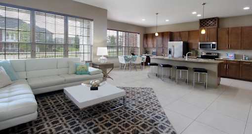 Luxury apartments with spacious open floor plan, granite countertops, stainless steel appliances, built-in wine rack, kitchen island, and porcelain tile floor at Bellemeade Apartments in west Des Moines