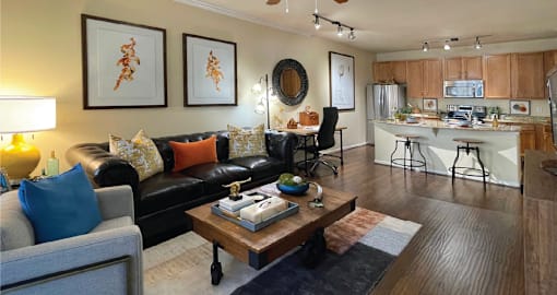 Luxury apartments with spacious open floor plan, hardwood floors, granite countertops, and stainless appliances at The Voss Apartments in Houston.