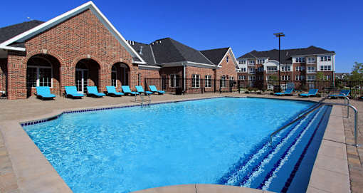Luxury apartments with swimming pool, poolside lounges, and brick exteriors at Bellemeade Apartments in west Des Moines