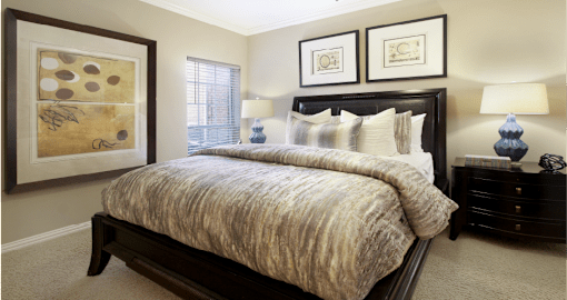 Luxury apartments with spacious bedrooms that can fit a king-size bed with attached bathrooms and walk-in closets at The Dorchester Apartments in north Dallas.