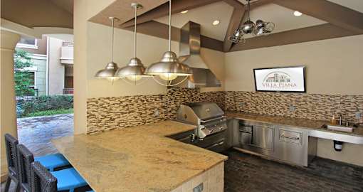 Luxury apartments with outdoor grilling station, granite bar top, and granite countertop at Villa Piana Apartments in Dallas