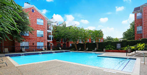 Luxury apartments with large swimming pool, multiple swimming pools, spa, and large sundeck with poolside lounge chairs at The Lanesborough Apartments in Houston