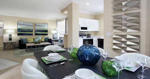 Spacious floor plan with u-shaped kitchen with white cabinets at Saddlebrook apartments in Urbandale Iowa