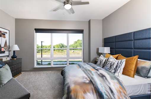 Luxury apartments with master bedroom to fit a king size bed, attached master bathroom and walk-in closet at Xenia Apartments in Golden Valley, Minnesota