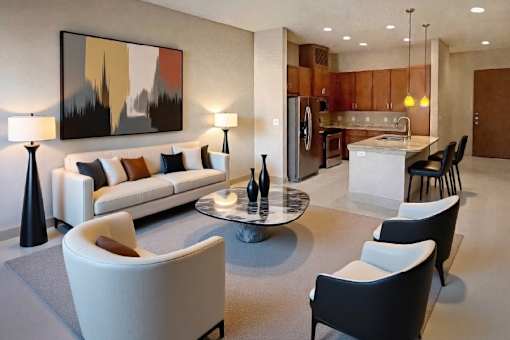 Spacious dining room with large bay windows and wood plank floors at Tuscany Park Apartments in Houston.