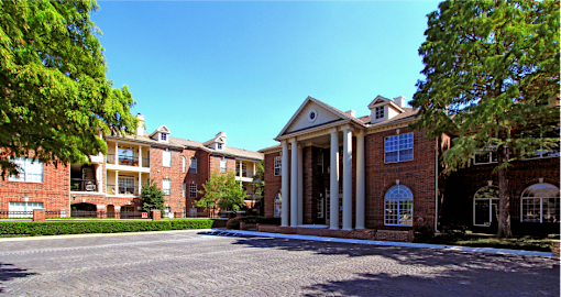 Gated apartment community near the Galleria in Dallas with luxury clubhouse and resident lounge, free wi-fi, meeting room, red brick exteriors, and beautiful landscaping at The Dorchester Apartments