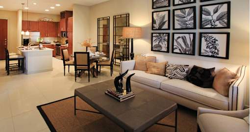 Luxury apartments next to the Galleria in Dallas with spacious floor plan, granite countertops, stainless steel appliances, built-in wine rack, kitchen island, and porcelain tile floor at Villa Piana Apartments in Dallas