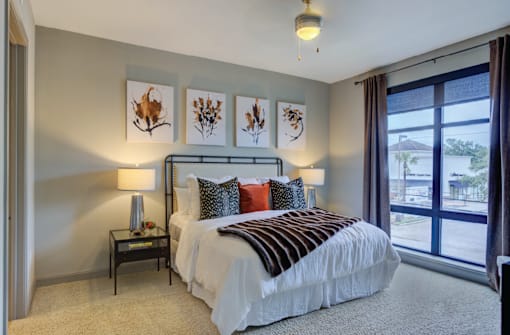 Spacious bedroom with 11-foot ceilings and walk-in closet at Le Palais Apartments in Houston.