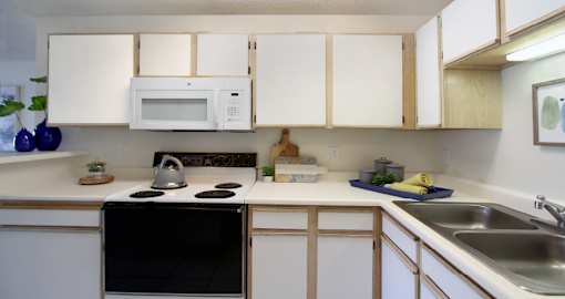 Spacious kitchen with extra cabinet space, extra counter space, tiled floors, bright white kitchen, at Tanglewood Apartments in Lincoln, Nebraska