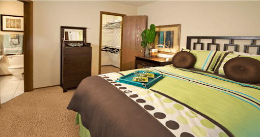 A bedroom with a bed, nightstand, and a dresser.
