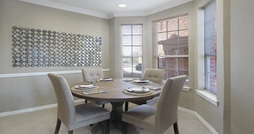 Luxury apartments in central Omaha with spacious dining room with bay windows, oversized windows, and crown molding at The Biltmore Apartments in Omaha, Nebraska