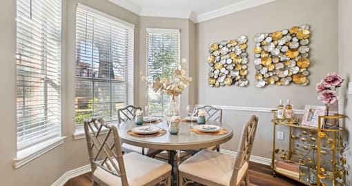 Spacious dining room with wood plank floors and oversized windows, luxury apartments in Dallas