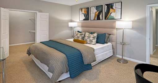 Spacious master bedroom with walk-in closet and ceiling fan at Breckenridge Apartments in Omaha, Nebraska