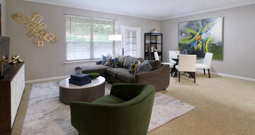 Spacious living room and dining room with huge windows and lots of natural light at Breckenridge Apartments in Omaha, Nebraska