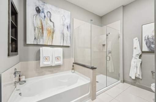Luxury bathroom with oval soaking tub and separate glass shower at Xenia Apartments in Golden Valley, Minnesota