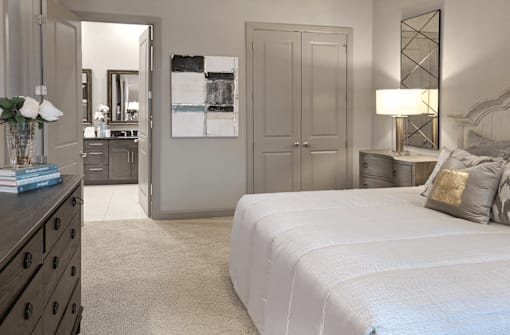 Spacious master bedroom with attached luxury master bath suite and 11-foot ceilings and walk-in closet at Le Palais Apartments in Houston.