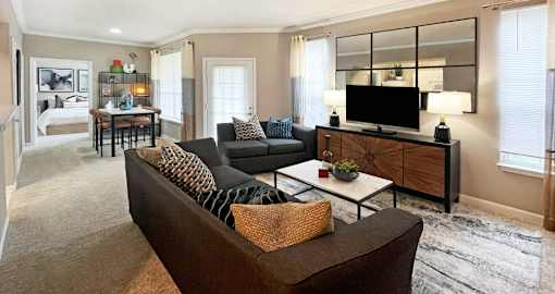 Spacious living room and dining room with huge windows and lots of natural light at Breckenridge Apartments in Omaha, Nebraska