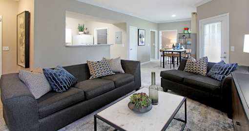 Apartments in southwest Omaha with open floor plan, open layout, spacious apartment, spacious living room, spacious dining room, lots of natural light, and huge windows at Breckenridge Apartments in Omaha, Nebraska