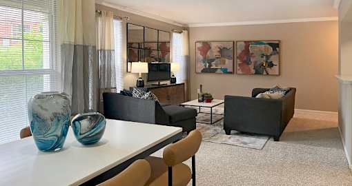 Apartments in southwest Omaha with open floor plan, open layout, spacious apartment, spacious living room, spacious dining room, lots of natural light, and oversized windows at Breckenridge Apartments in Omaha, Nebraska
